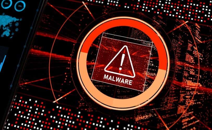 A ilustração mostra um alerta de malware que está prestes a invadir um sistema. O aviso está em vermelho, no centro da tela, sobre uma série de pequenas linhas de códigos de programação.